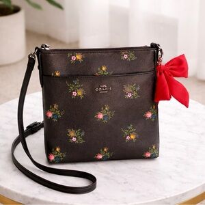 Coach Black Floral Crossbody Bag with Red Bow.

Coach floral bag 🌸